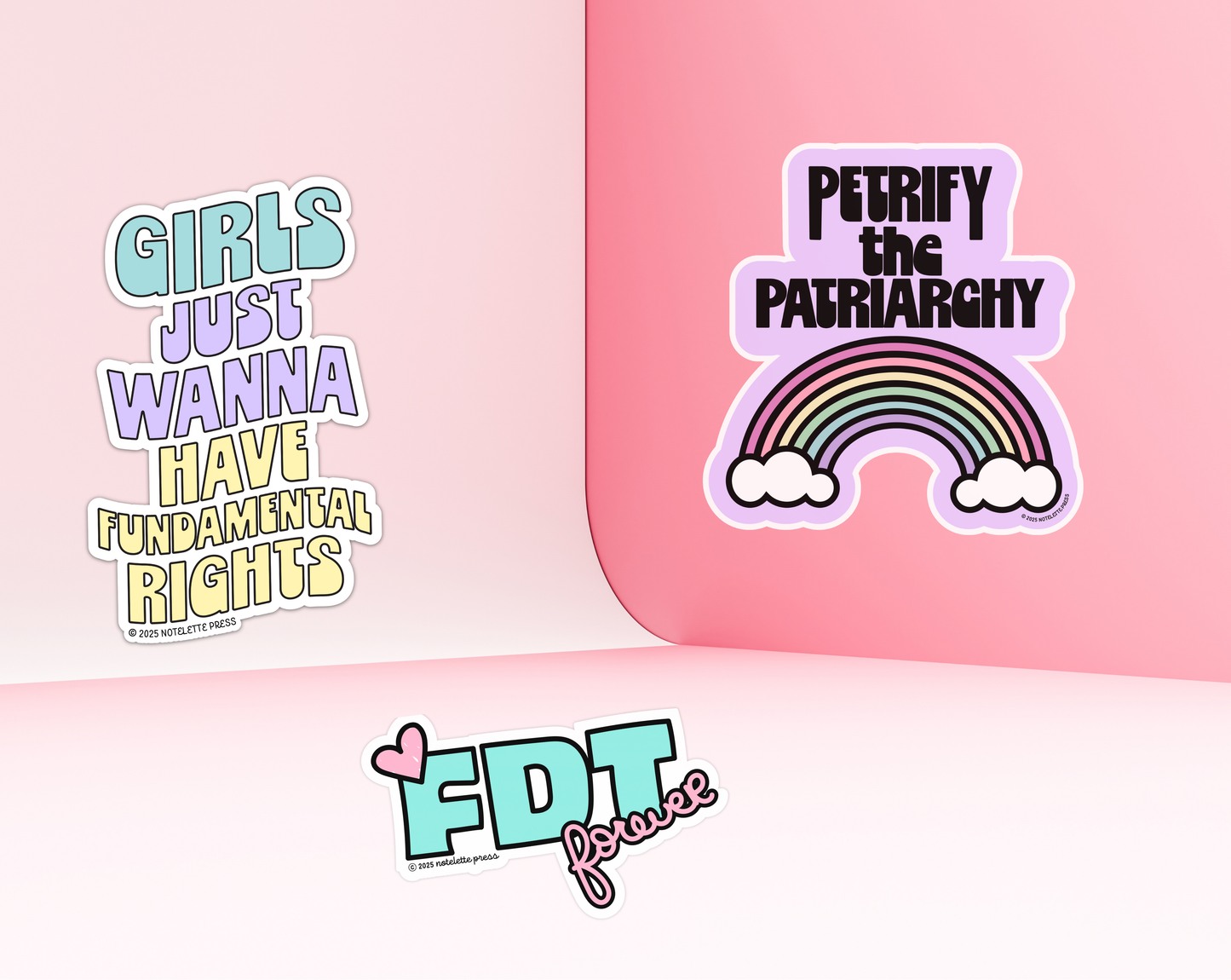 Stickers with feminist text and graphics on a pink background