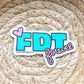 Sticker with 'FDT forever' text on a woven mat